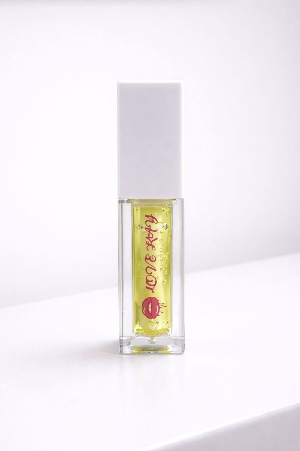 Sunny Lemon lip gloss in a clear tube, featuring bright yellow formula and playful packaging.