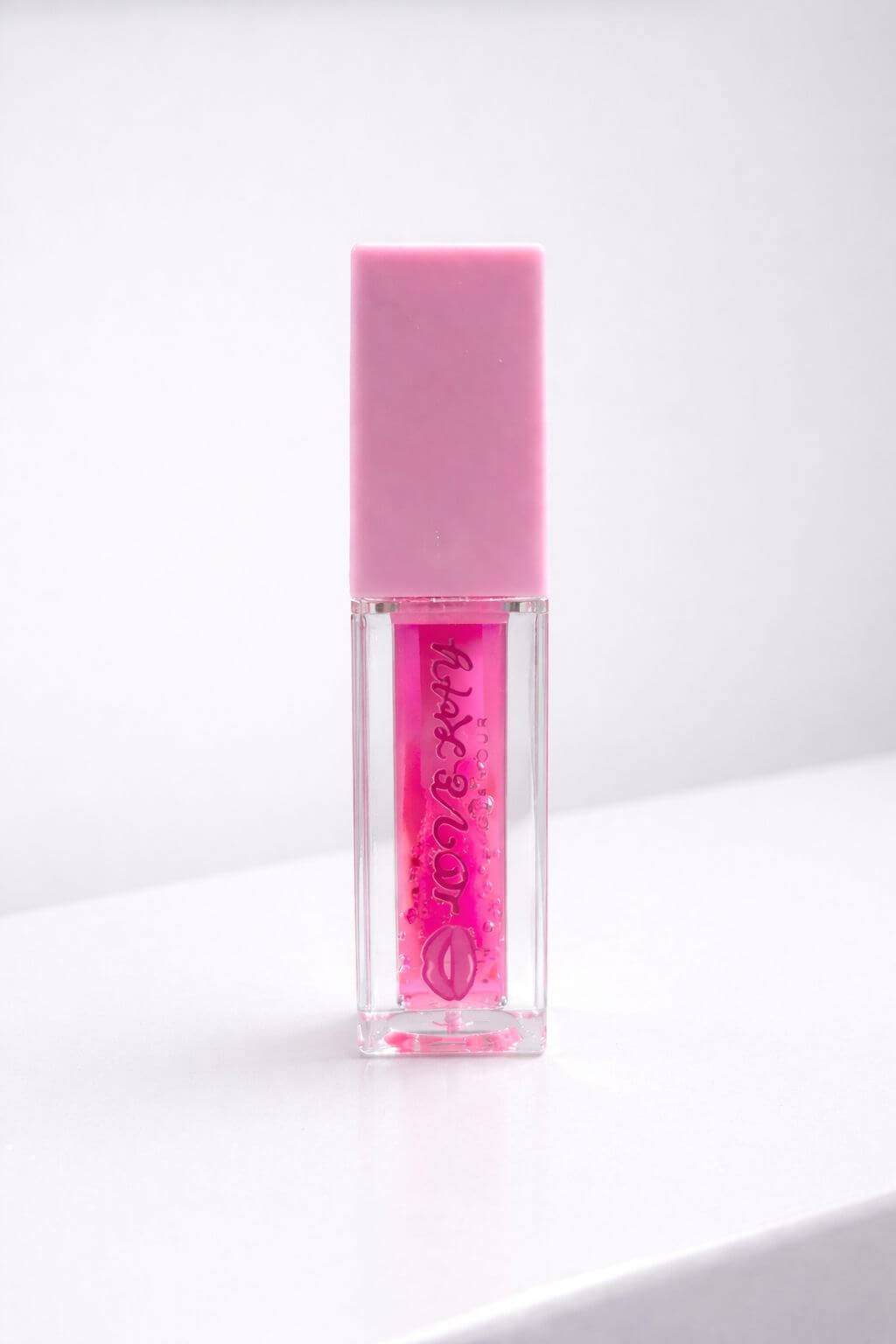 Berry Sparkle fruity lip gloss in a clear tube with pink cap, perfect for adding a sweet sparkly touch to smiles.