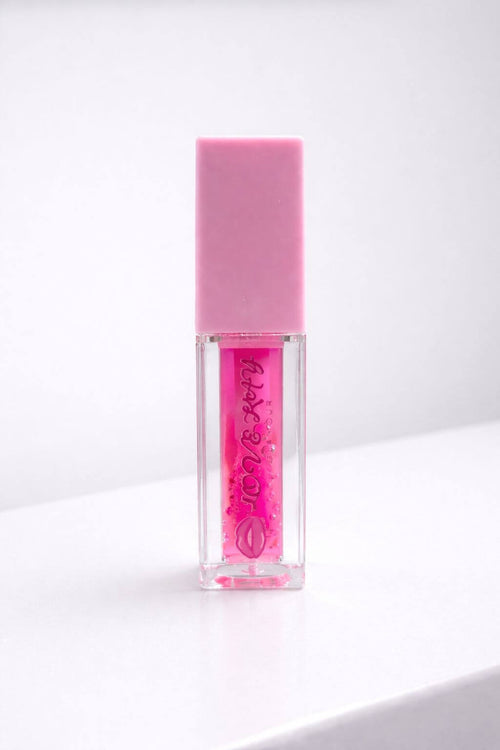 Berry Sparkle fruity lip gloss in a clear tube with pink cap, perfect for adding a sweet sparkly touch to smiles.